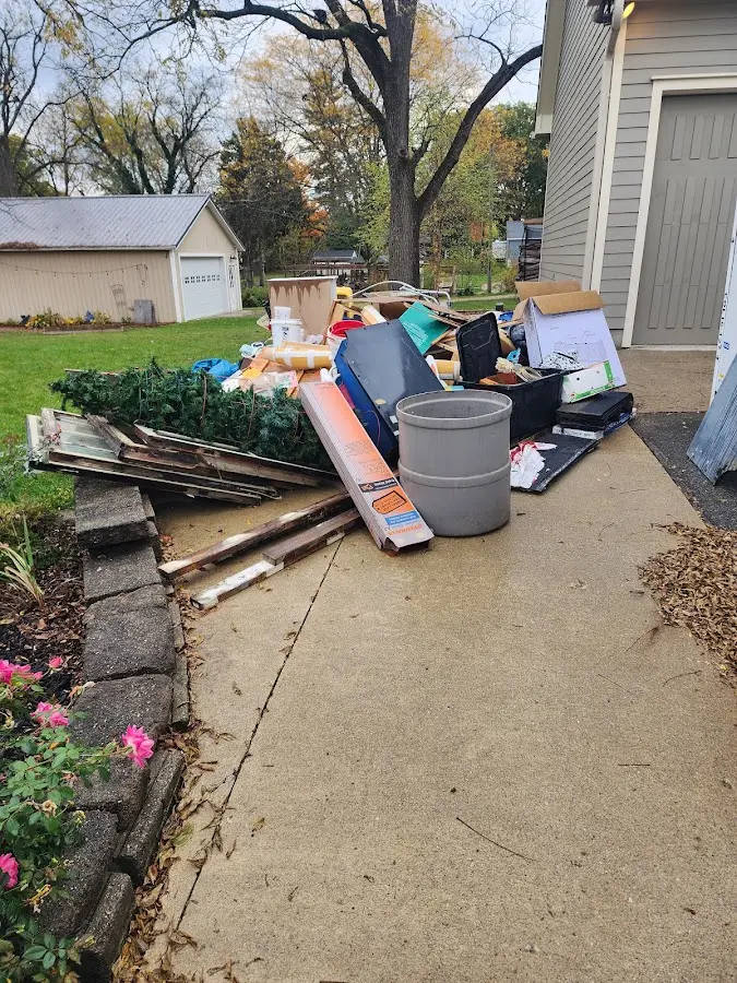 Dumpster being loaded with debris for 12 Yard Dumpster Rental in Chincoteague